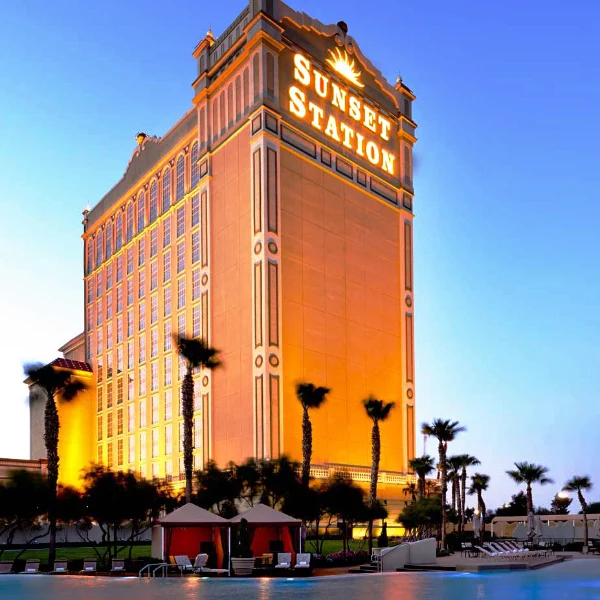 This is an image of the The pool and the casino at Sunset Station at sunset