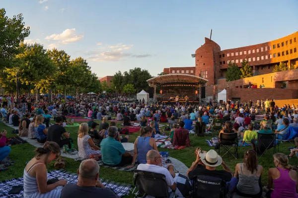 Crowd attending a live outdoor event on the lawn at Clark County Government Center Amphitheater in Las Vegas.