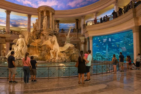 Families gather near the Fall of Atlantis fountain and aquarium inside The Forum Shops at Caesars Palace.