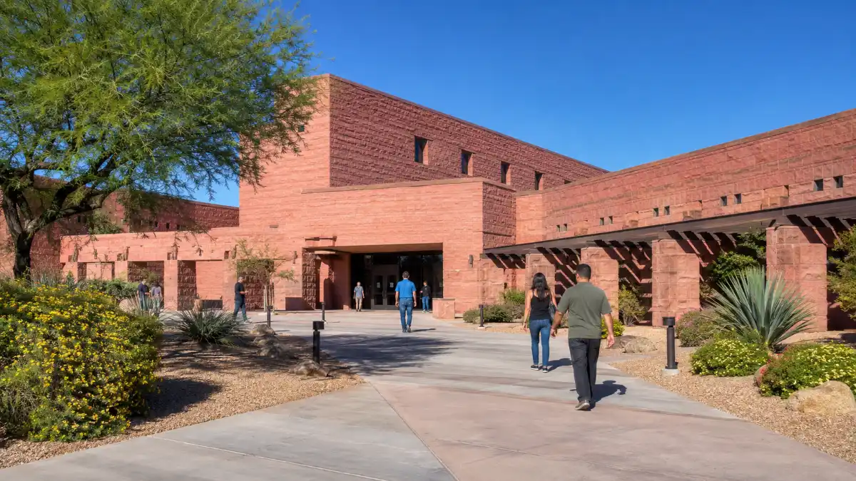 Red sandstone exterior and landscaped entrance of the Clark County Government Center in downtown Las Vegas.