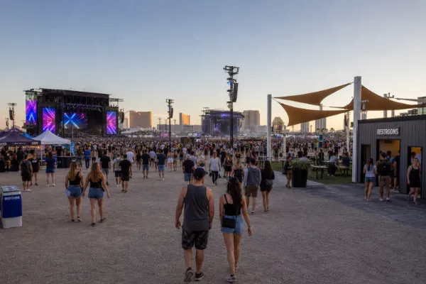 Festival attendees move between stages and visitor-service areas inside Las Vegas Festival Grounds.