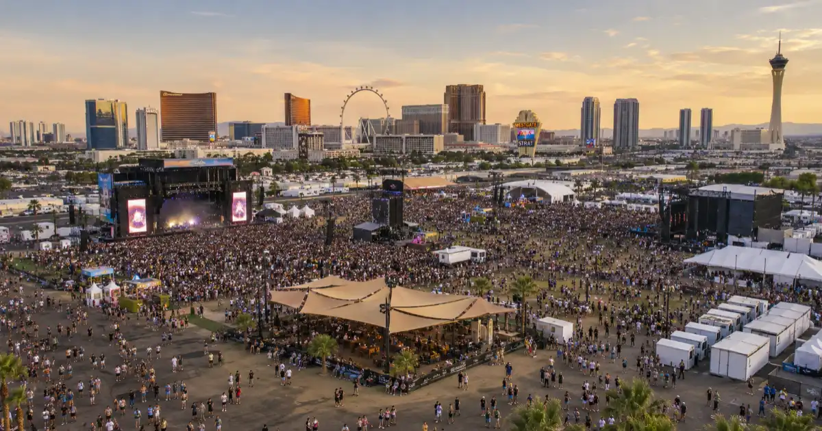 A large outdoor festival fills Las Vegas Festival Grounds with multiple stages and audience areas near the north end of the Strip.