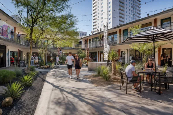 Visitors gather among local storefronts, landscaping, and historic motel architecture in the courtyard at Fergusons Downtown.