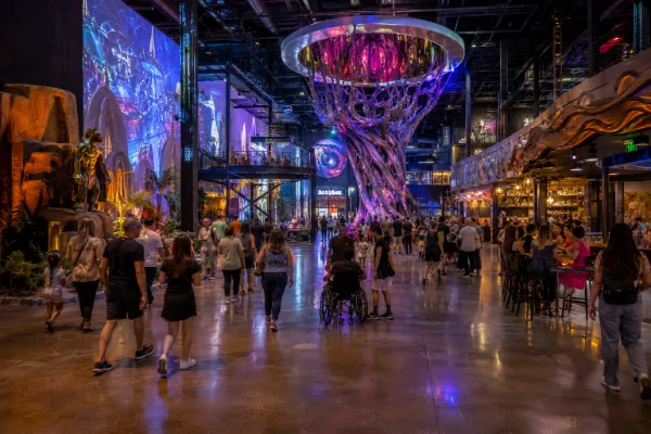 Visitors explore monumental art and attraction entrances inside the AREA15 entertainment district in Las Vegas.