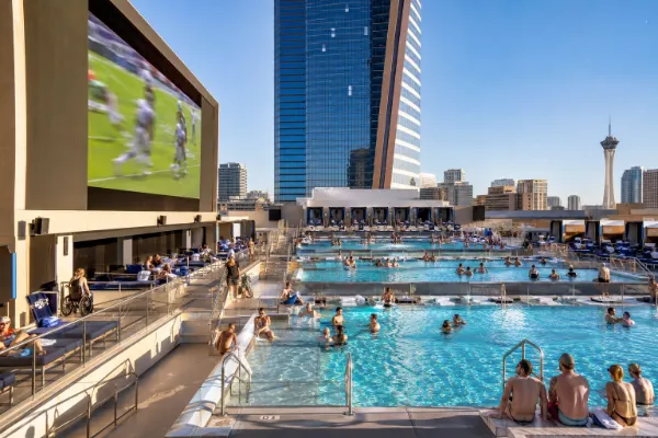 Adult guests enjoy the tiered pools and large sports screen at Stadium Swim at Circa Resort & Casino.