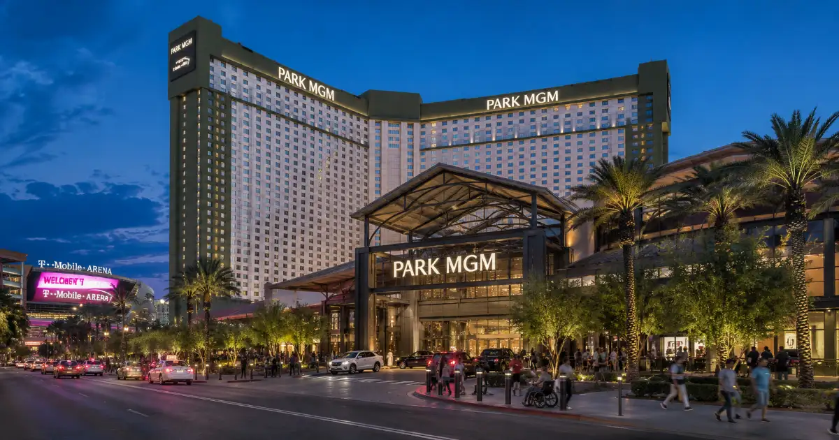 Park MGM's hotel tower and entrance glow along the Las Vegas Strip at blue hour.