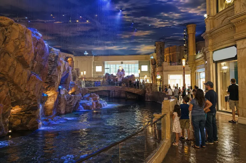 Visitors watch the indoor Rain Show water feature inside Miracle Mile Shops at Planet Hollywood.