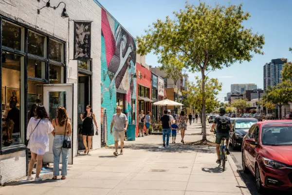 Pedestrians explore galleries, murals, shops, restaurants, and independent businesses in the Las Vegas Arts District.