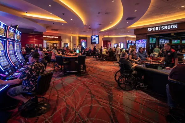 Adult guests play slots, video poker, and table games inside the casino at OYO Hotel & Casino Las Vegas.