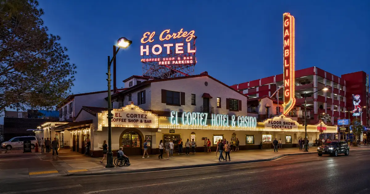 The historic El Cortez Hotel and Casino facade and neon signs glow along Fremont Street in Downtown Las Vegas.