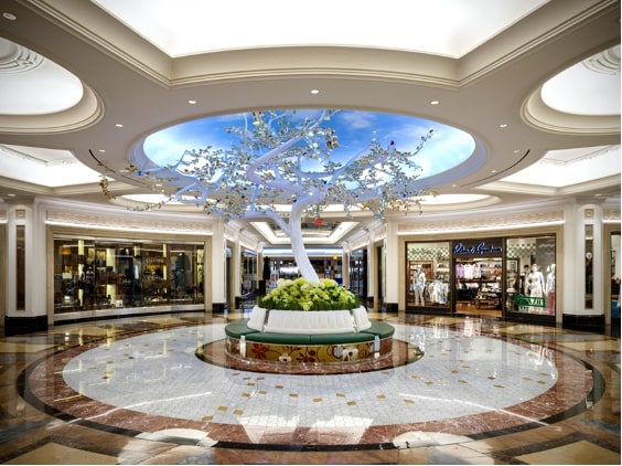 White Wishing Tree sculpture with golden brass leaves and colorful glass birds at Grand Canal Shoppes