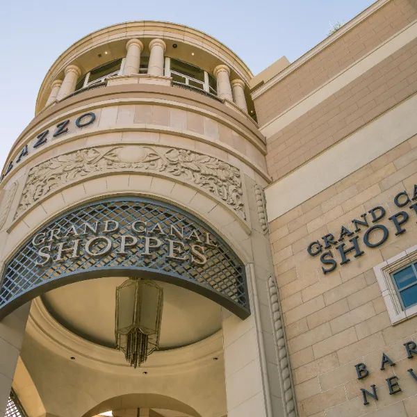 The exterior of the Grand Canal Shoppes in Las Vegas, showing the ornate, Italian-inspired architecture and the Grand Canal Shoppes sign