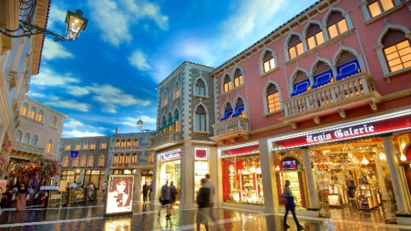 Indoor shopping promenade at Grand Canal Shoppes in The Venetian Las Vegas, featuring Venetian-style architecture, painted sky ceiling, and boutique storefronts along a polished cobblestone walkway