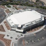Aerial view of Lee’s Family Forum arena in Henderson, Nevada with white roof, parking lots, and landscaped surroundings