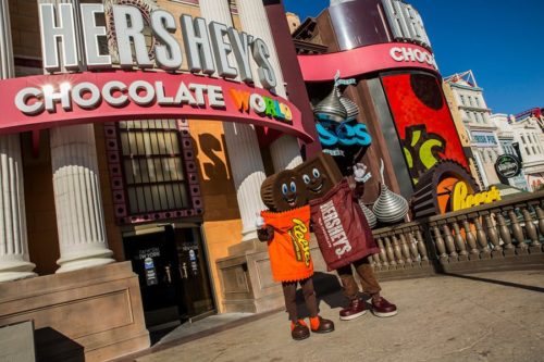 Hershey Bar and Reese's Peanut Butter Cup characters wave at passersby outside Hershey Chocolate World on the Las Vegas Strip.