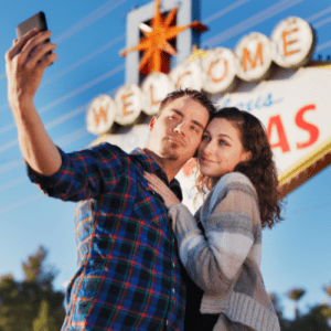 Couple taking a selfie in front of the Welcome to fabulous Las Vegas Sign