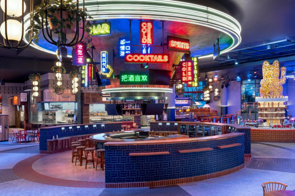 Colorful bar and international food stalls inside Famous Foods Street Eats at Resorts World Las Vegas