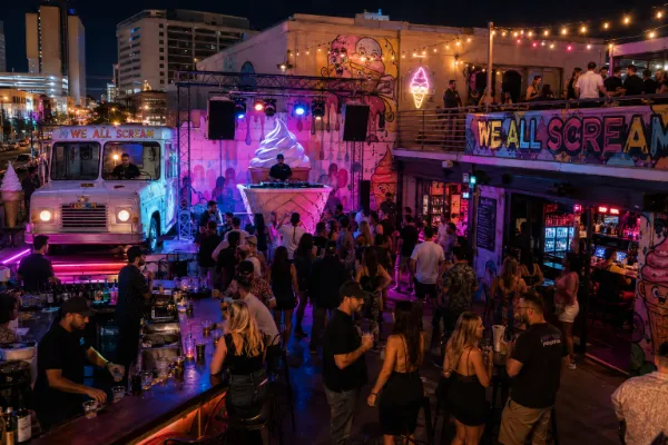 Adults enjoy music, drinks, colorful art, and rooftop nightlife at We All Scream in Downtown Las Vegas.