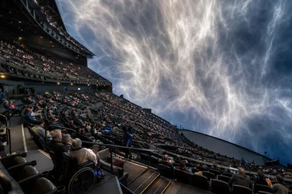 Guests sit within the steeply tiered auditorium and wraparound immersive display inside Sphere Las Vegas.