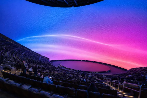 Steep tiered seating surrounds the performance area and wraparound interior display inside Sphere Las Vegas.