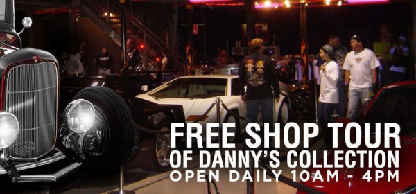 A group of people taking the free showroom tour at Danny Koker's Count's Kustoms shop
