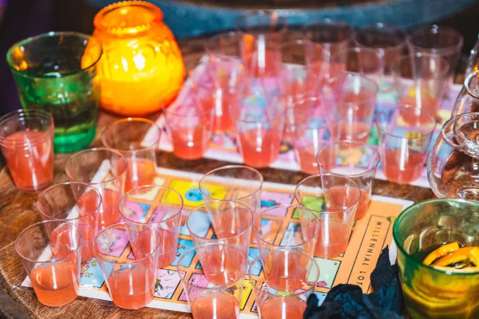 This is a picture of a table with shots of tequila on a game board at Tequila Loteria Party at Lucky Day in Las Vegas