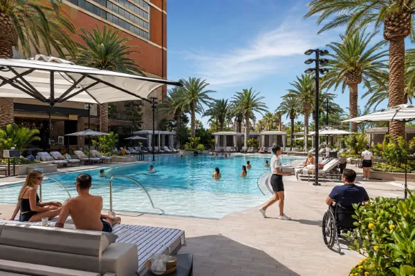 Guests relax among palm trees, cabanas, and lounge seating at Bel-Aire Backyard at Durango Casino and Resort.