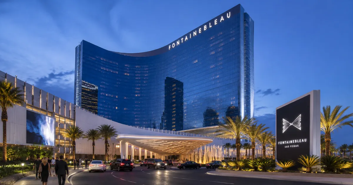 The tall blue-glass tower, permanent rooftop sign, and modern entrance architecture identify Fontainebleau Las Vegas on the north Strip.