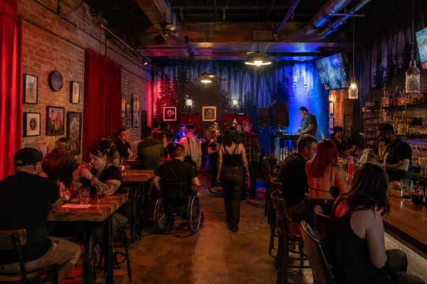 Adults enjoy cocktails, music, and dancing inside Raised by Wolves at Neonopolis in Downtown Las Vegas.