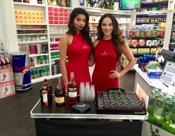2 women are giving away sample of liquor at the The Liquor Library inside Harry Reid Airport