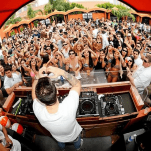 The DJ keeps the crowd dancing during an EDM pool crawl in Las Vegas