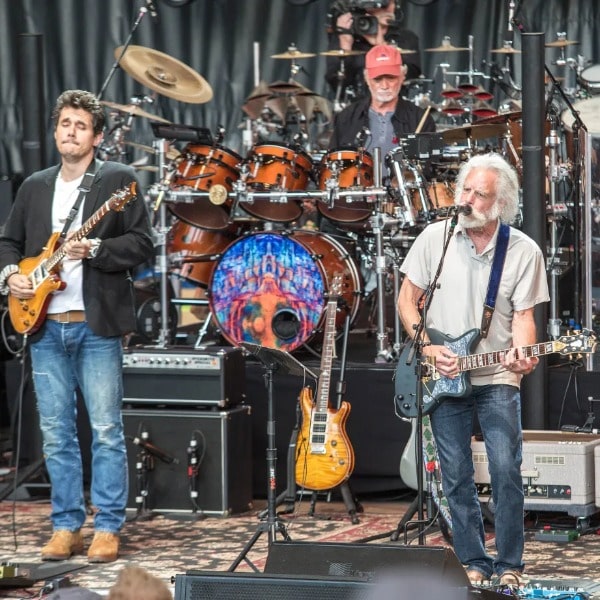 Dead and Comapny's Bob Weir, Bill Kreutzmann, and Mickey Hart playing in a concert