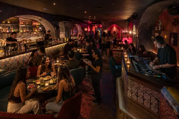 Guests enjoy tacos, cocktails, and DJ music inside the hidden Más Por Favor speakeasy in Las Vegas.