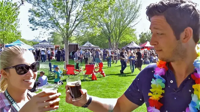This is a picture of two people cheersing their beer samples at the Boulder City Beerfest 2024