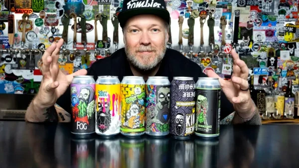 This is a picture of a row of beers with the brew master at Beer Zombies Las Vegas Brewery