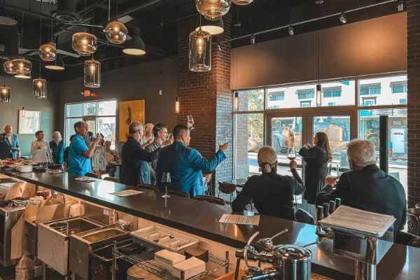 This is a photo of a gathering of people sampling and learning about wine at Garagiste Wine Room and Merchant in the Las Vegas Arts District