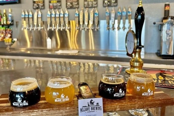 This is a picture of a row of taps and a flight of beer tasters at Mojave Brewing Company in downtown Henderson