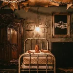This is a picture of The Basement Escape Room and a zombie guy is crawling out of a bed