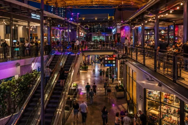 Visitors explore the dining, nightlife, shopping, and entertainment levels inside Neonopolis.