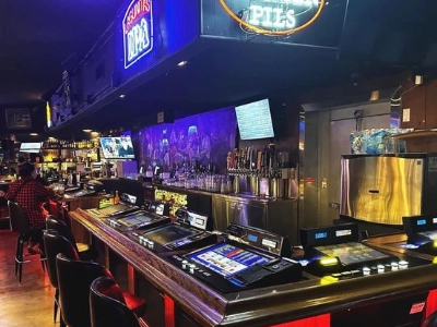 interior of hard hat lounge dive bar in las vegas with video poker machines neon signs and vintage bar counter
