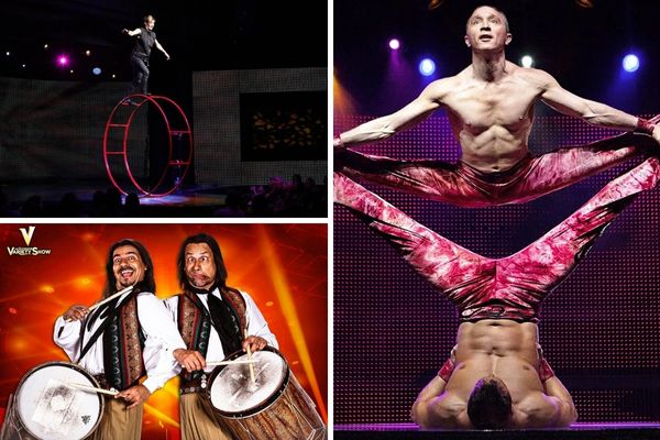 A promotional image for V - The Ultimate Variety Show, showing a variety of acrobats and dancers performing on a stage with a brightly lit backdrop.