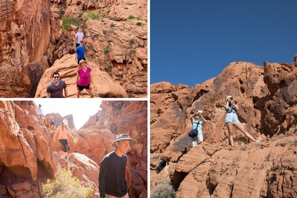 Group of hikers navigating a narrow red rock canyon in Valley of Fire State Park, surrounded by dramatic sandstone walls. One person poses on a rocky outcrop while another captures the moment, highlighting the adventure and scenic beauty of the guided tour.