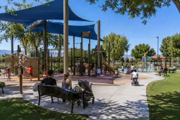Families use a shaded playground and paved paths at Craig Ranch Regional Park in North Las Vegas.