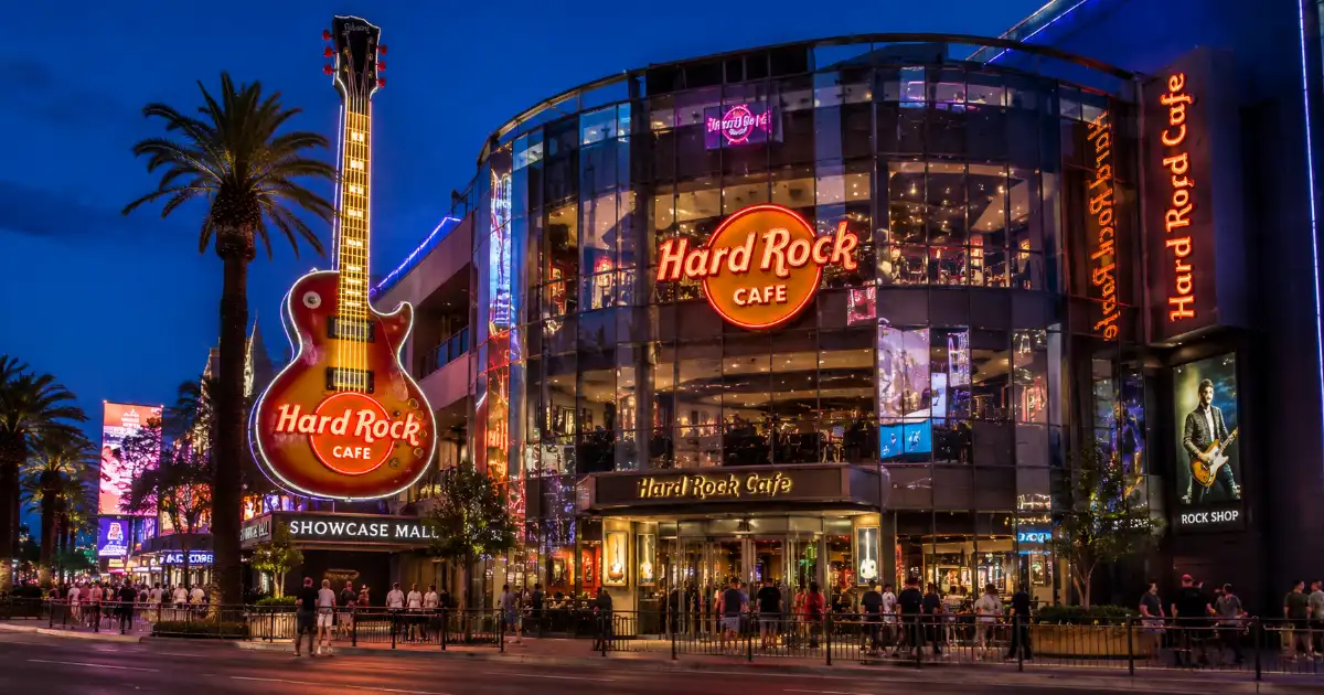 Hard Rock Cafe Las Vegas Strip exterior with its illuminated guitar sign and entrance at Showcase Mall.