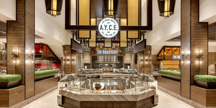 A view of the modern interior of the Palms AYCE (All You Can Eat) buffet in Las Vegas, showing the central food stations and "The Roastery" sign in the background.