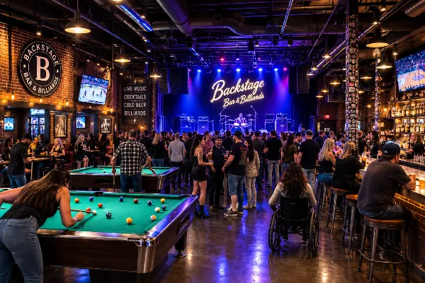 Adult guests gather near the stage and billiards tables inside Backstage Bar & Billiards in Downtown Las Vegas.
