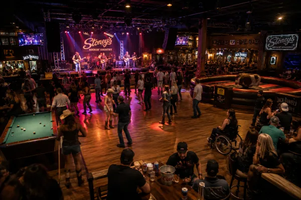 Guests line dance and watch live country music inside Stoney’s Rockin’ Country at Town Square Las Vegas.