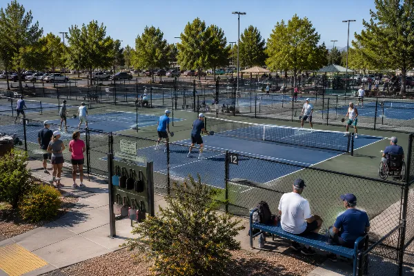 Adults play recreational doubles across several courts at the Sunset Park Pickleball Complex in Las Vegas.