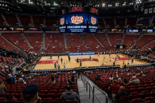 Red seating surrounds the basketball court and central scoreboard inside Thomas & Mack Center at UNLV in Las Vegas.