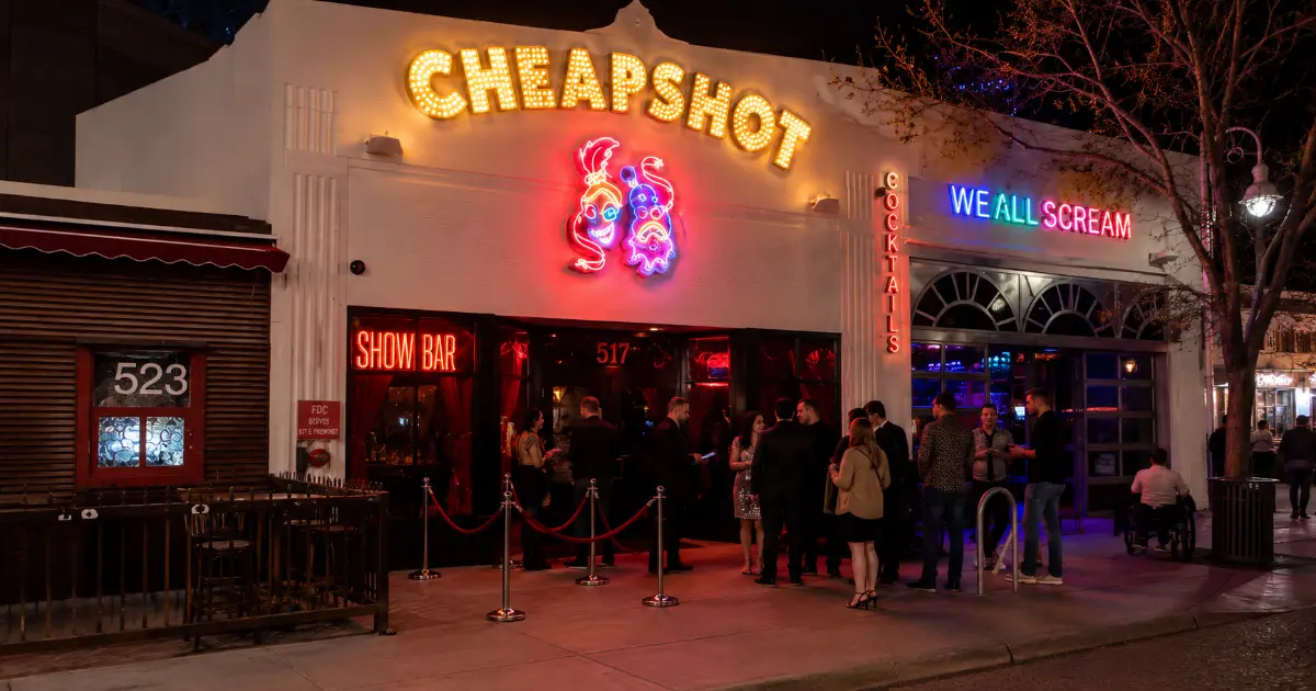 Adult nightlife guests approach the neon-lit Cheapshot showroom entrance on Fremont East in Downtown Las Vegas.